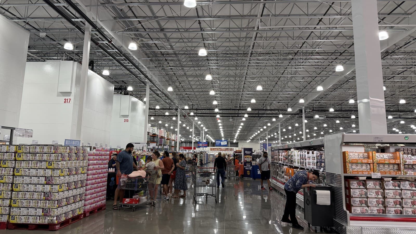 Shoppers in the aisles at the new Costco on South Preston Road in Celina, which opened Aug. 26. Staff photo.