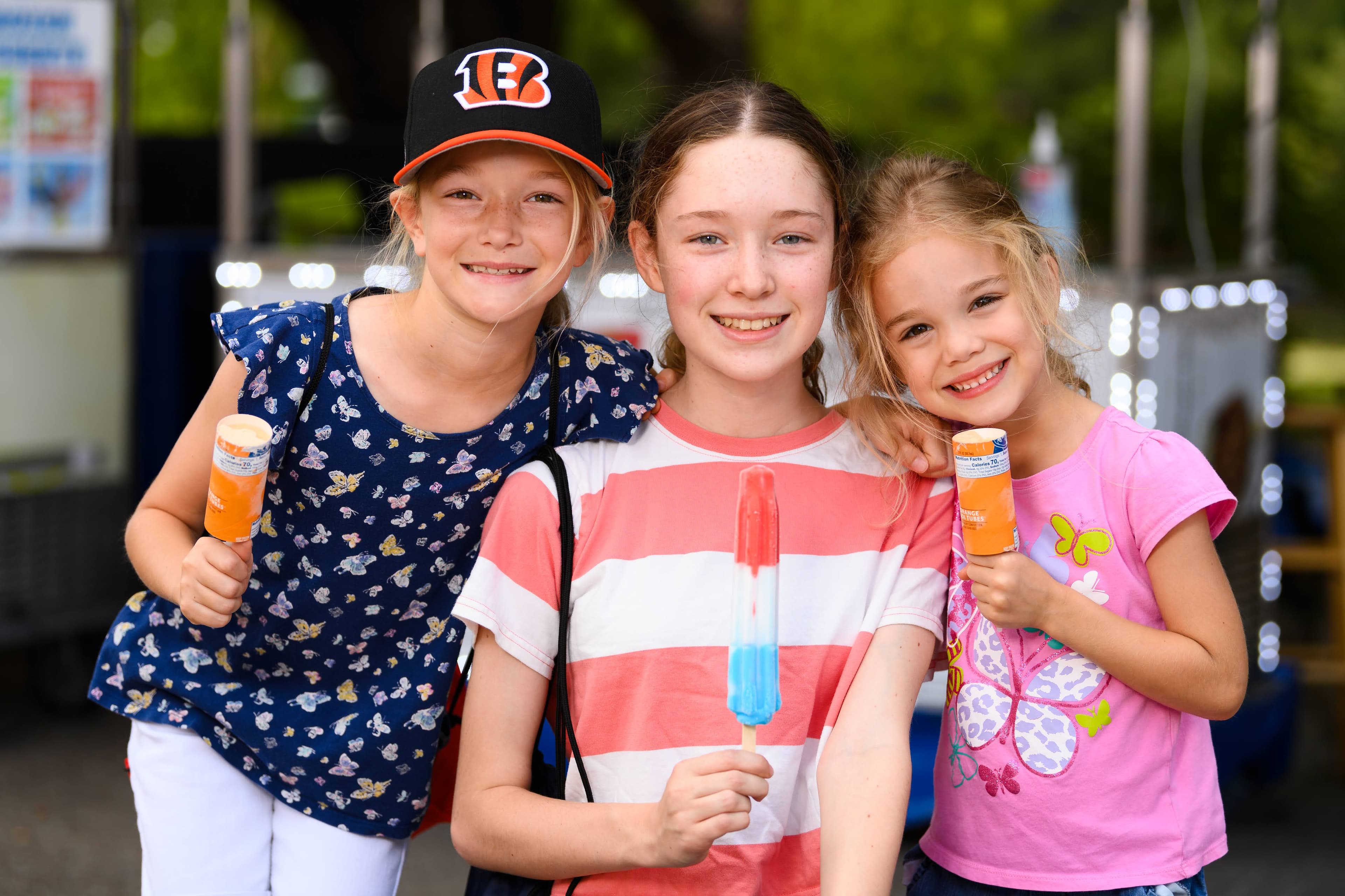 File photo: Three children pose with frozen treats at the fair.