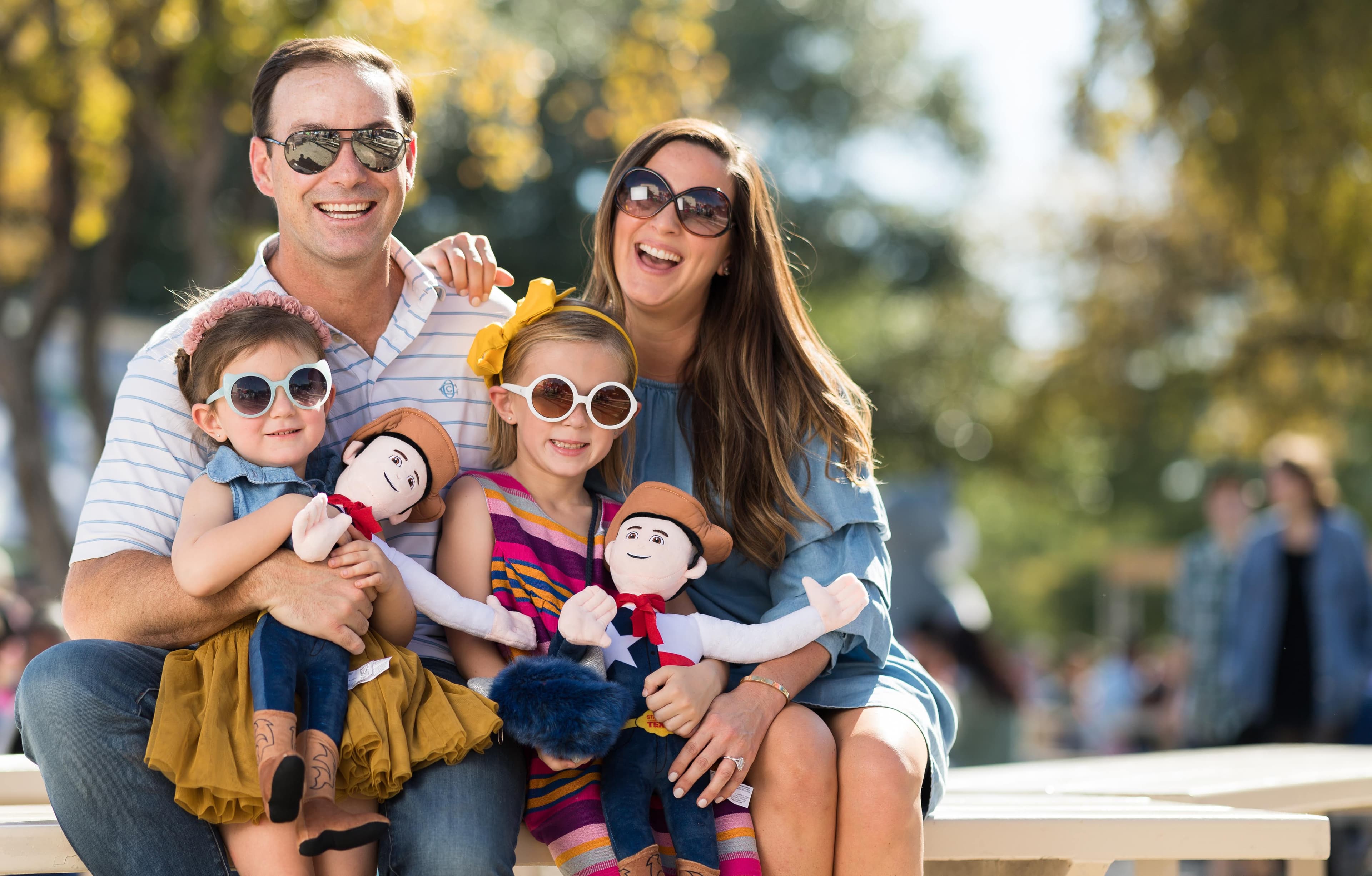 File photo: Adults and children pose with cowboy dolls at the State Fair of Texas.